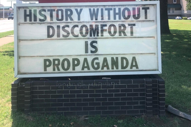 sign that says "history without discomfort is propoganda"