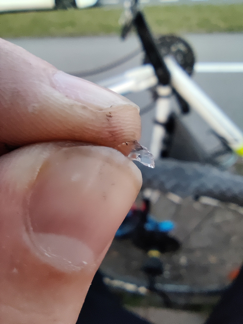Macro photo of a glass shard taken out of a flat bike tire