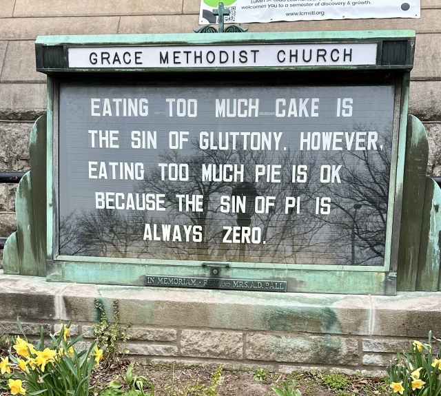 Grace Methodist Church sign reading “Eating too much cake is the sin of gluttony. However, eating too much pie is ok because the sin of pi is always zero.”