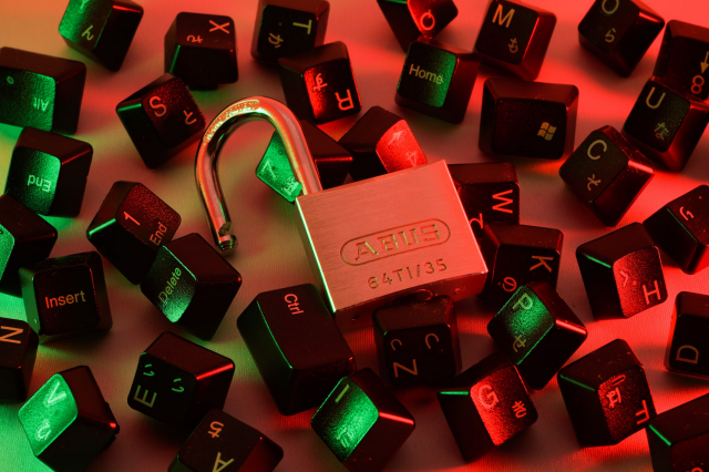 This image shows a random number of keyboard keys with an open padlock on top of them.