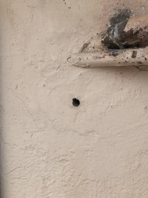 That hole goes to a water pipe. The valve is closed now so there's no water coming out.