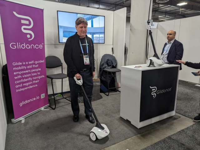 Amos Miller demonstrates the Glidance mobility aid at an exhibition