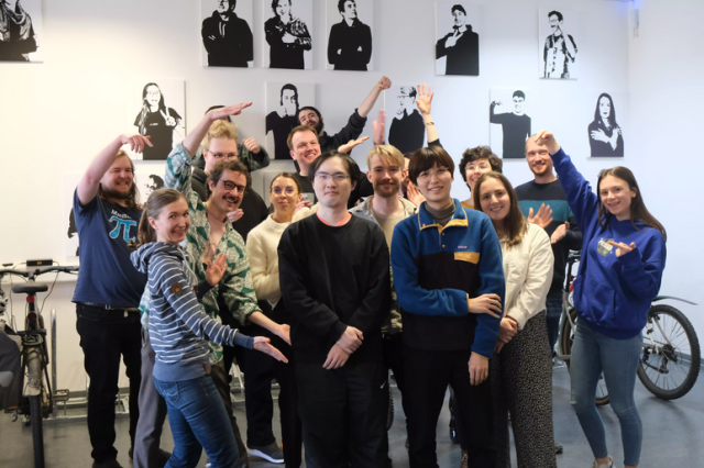 The image shows the Tuta Team celebrating with new employees in the foreground.