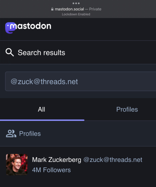 Screenshot of me searching mastodon.social for Mark Zuckerberg’s Threads profile, @zuck@threads.net, and it appears. It shows his profile picture of him smiling against a red bokeh blur background. It also shows he has 4 million followers, which just by federating Threads with the Fediverse would automatically make him the most followed person in the Fediverse.