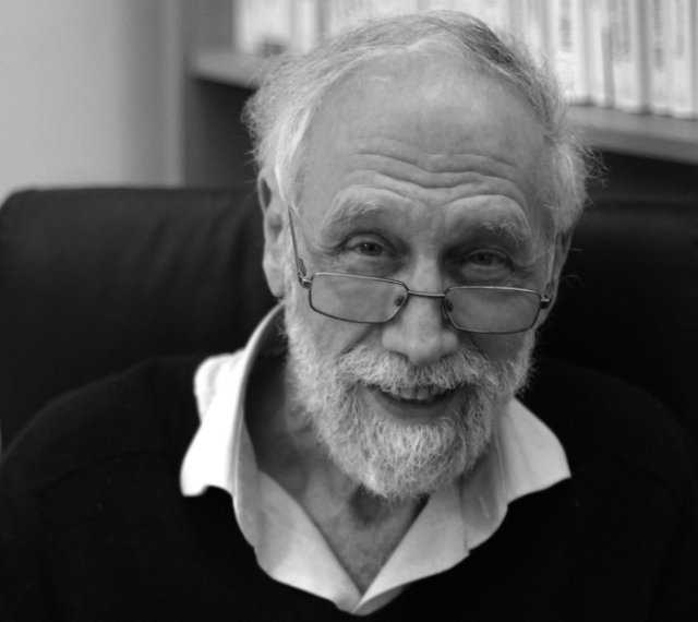 Photograph of Alain Connes, glasses slid down his nose a bit, looking in a kindly way at us, from here:

https://www.voyages-d-affaires.com/alain-connes-carnet-voyages-20180503.html