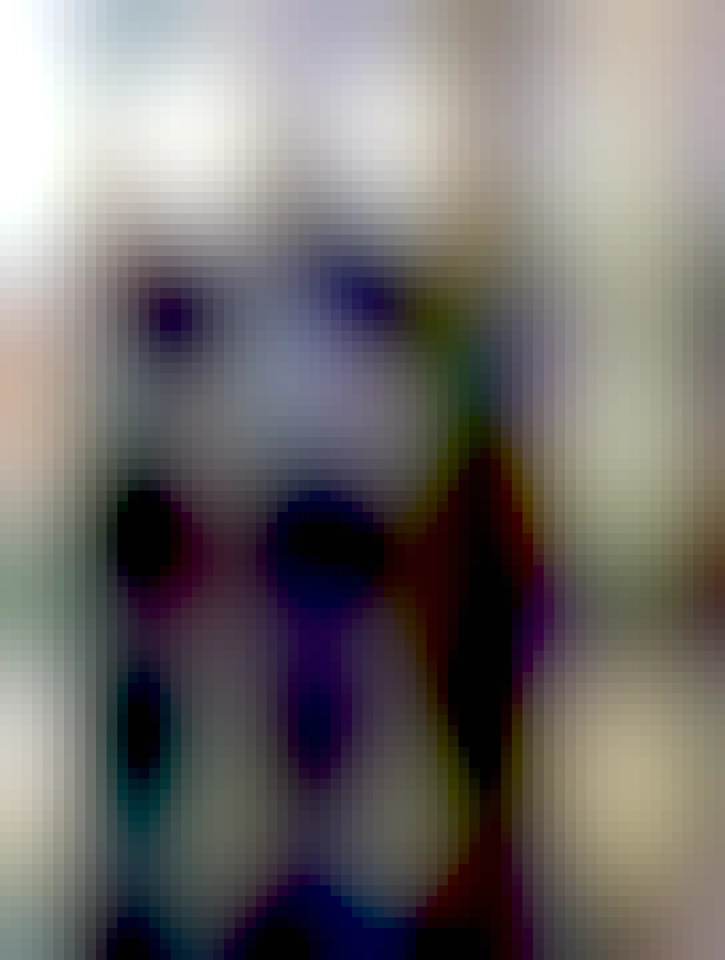 A picture of a crow in the style of a selfie, with the background being some university. The caption says "I left you shiny things plz respond"