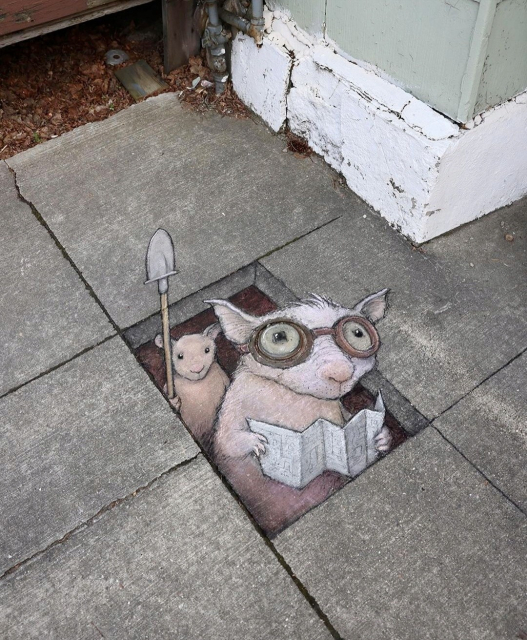 Streetart. Two possums (or rats?) and a hole with a 3D effect were painted with chalk on a sidewalk made of rectangular concrete slabs. The two beige possums wear protective goggles and look out of the rectangular painted hole. The one in front is holding a folding map, the one behind is holding up a spade. Title: Ronan and Pete are definitely not up to anything, but they would like to know if you have a compass they could borrow."