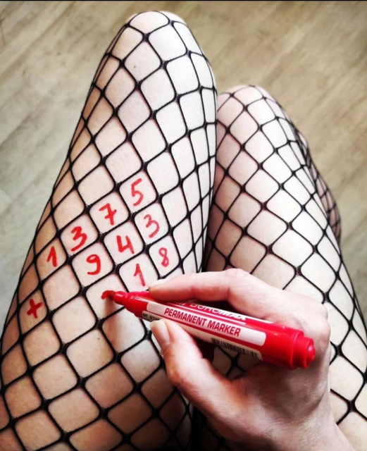 Photography. A color photo of a mathematical calculation in an unusual place. The photo shows the legs of a woman in large-mesh black fishnet stockings. She has a red felt-tip pen in her hand and is writing numbers in the gaps. It says 1375, underneath + 943 and she begins to write a number underneath in front of the 18. (Probably the result = 2318)
Simply an cool photo idea.