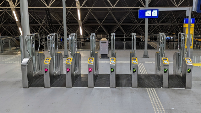 A row of station access gates fully open, apparently after an abuse of the emergency evacuation button.