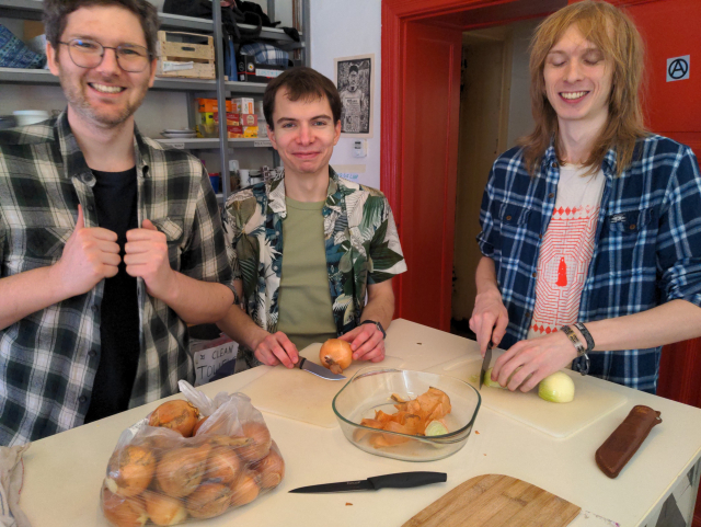 Three hackers cutting vegetables.