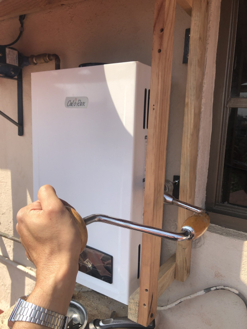 A brace and screw bit, being used to drive a screw in a really uncomfortable position.