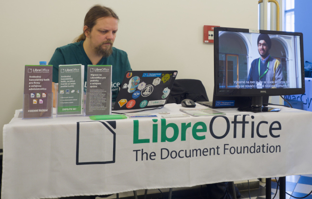 Photo of LibreOffice booth with flyers and a video