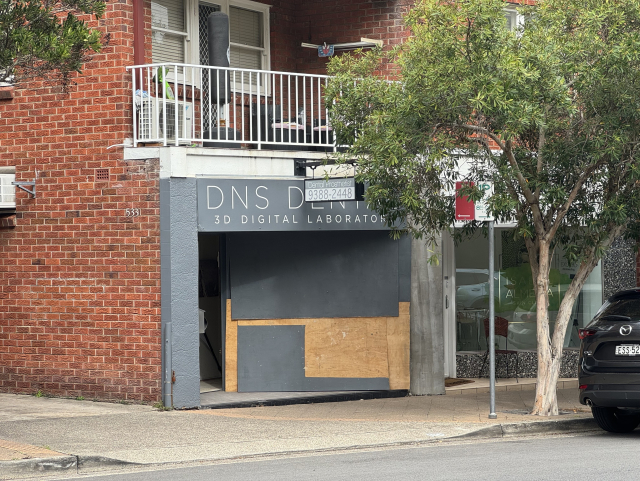 A storefront with the banner “DNS DENTAL”