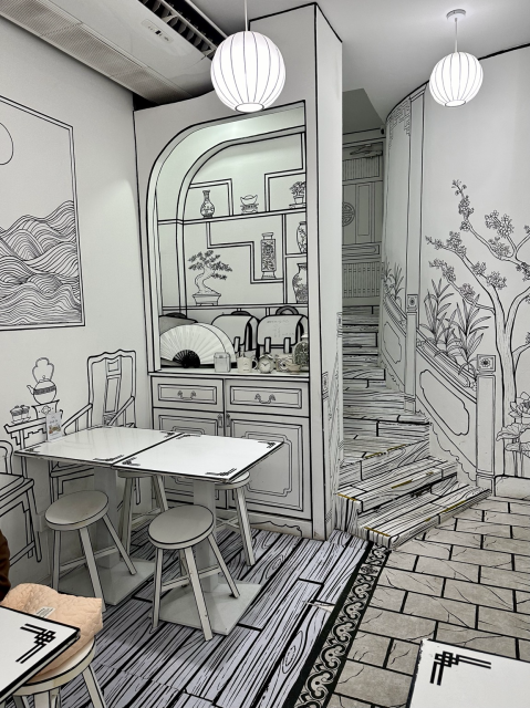 The whole cafe is covered in white with black lines made to look like a sketch.