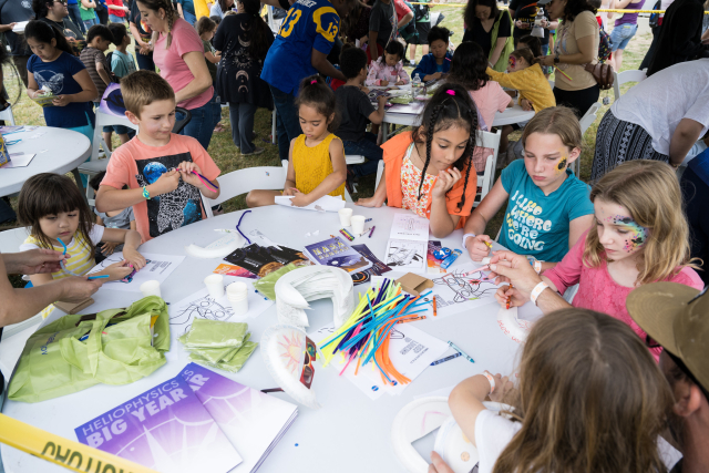 Children work on art projects during the Kerrville eclipse festival in Kerrville, TX on Mond