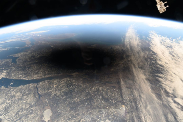 The Moon's shadow, or umbra, is pictured covering portions of the Canadian provinces of Quebec and New Brunswick and the American state of Maine in this photograph from the International Space Station as it soared into the solar eclipse from 261 miles above.