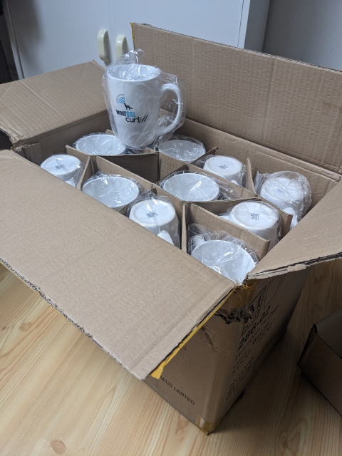 a big box of "curl contributor" coffee mugs