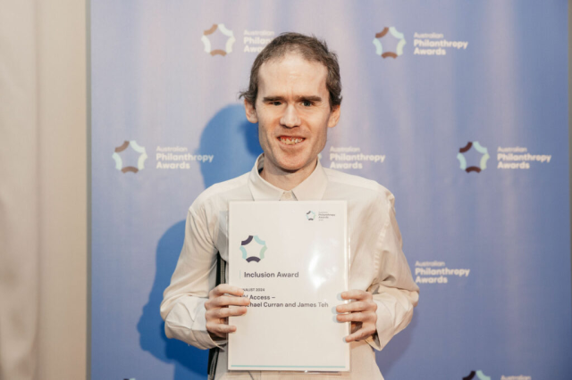 Michael Curran at the Australian Philanthropy Awards holding the Finalist certificate for the Inclusion award.