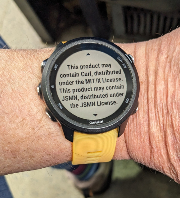 A photo of the Garmin Forerunner 245 on my wrist, displaying text "This product may contain Curl, distributed under the MIT/X License."