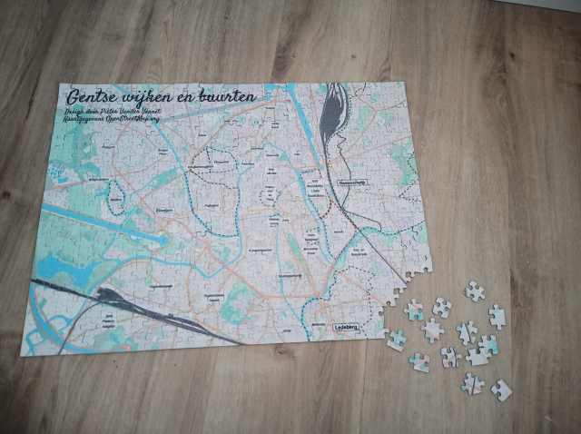 A puzzle which shows a map of Ghent. The neighbourhoods are labeled.
It has a title in the top-left, saying 'Gentse Wijken en buurten' (Neighbourgoods of Ghent), wit attribution to me and OpenStreetMap