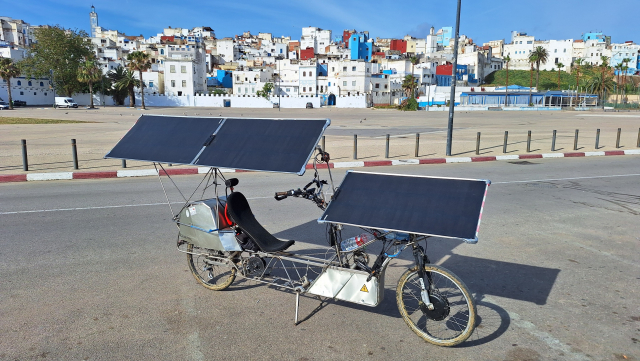 Recumbent solar bike at Larache, Morroco. White houses of coastal city in the background.