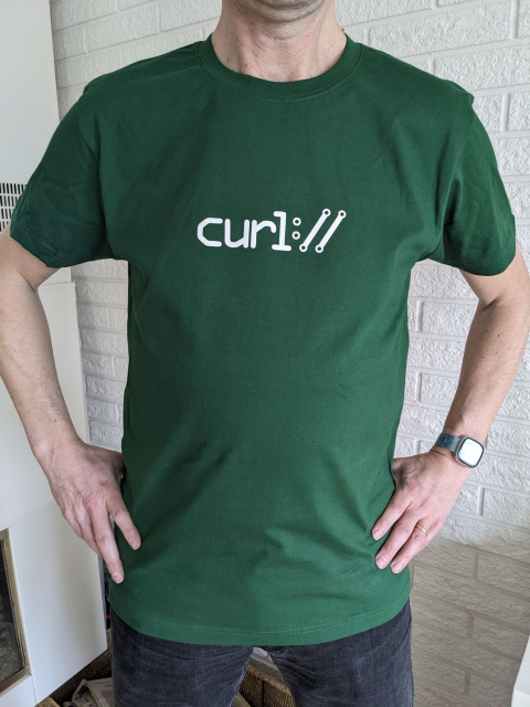 A green tshirt with a white curl logo