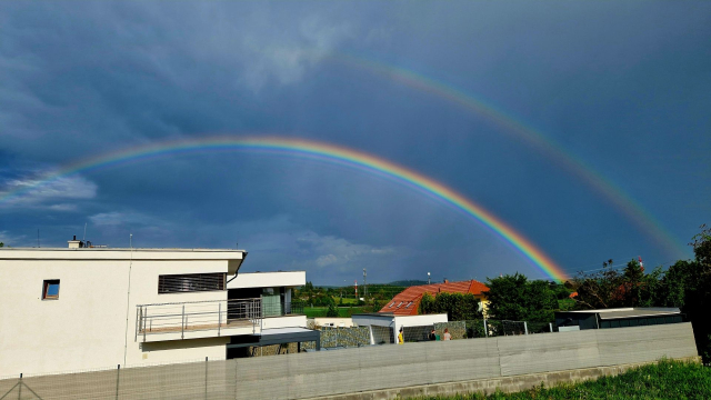 Two rainbows in a rather dark sky.