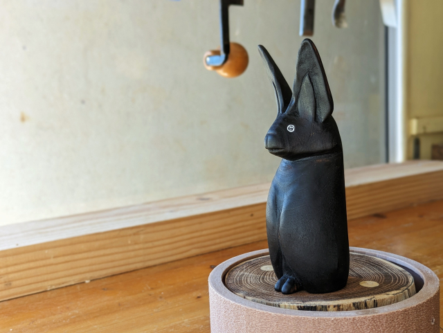 Woodcarved standing bat