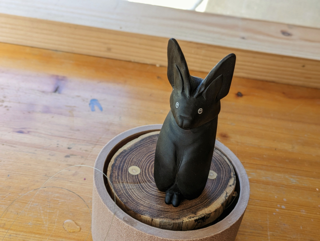 Woodcarved standing bat