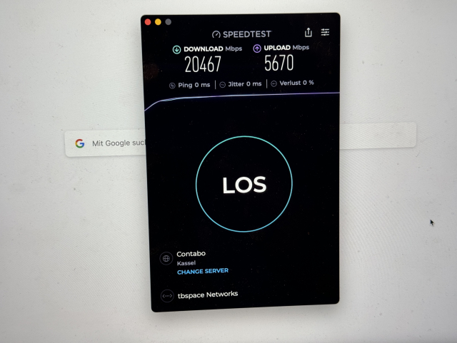 Photo of a Mac screen, showing Speedtest.net app with 20467 MBit/s download, 5670 MBit/s upload