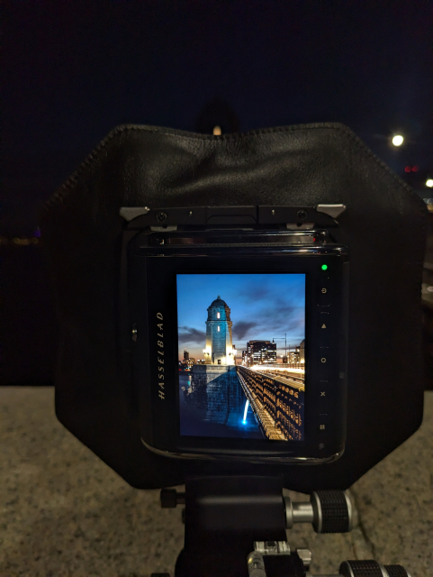 A photo of a Hasselblad digital camera mounted to a Cambo rear standard taking a photo of Boston's Longfellow bridge.