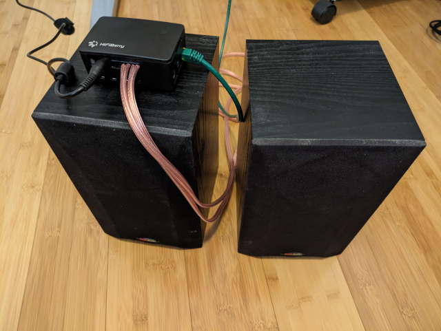 Raspberry Pi 4B with HiFiBerry sitting on top of a pair of bookshelf speakers (the ones I used to use with my original Sonos ZonePlayer 100).