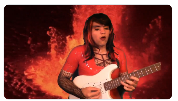 Silver Spook playing guitar in front of volcano