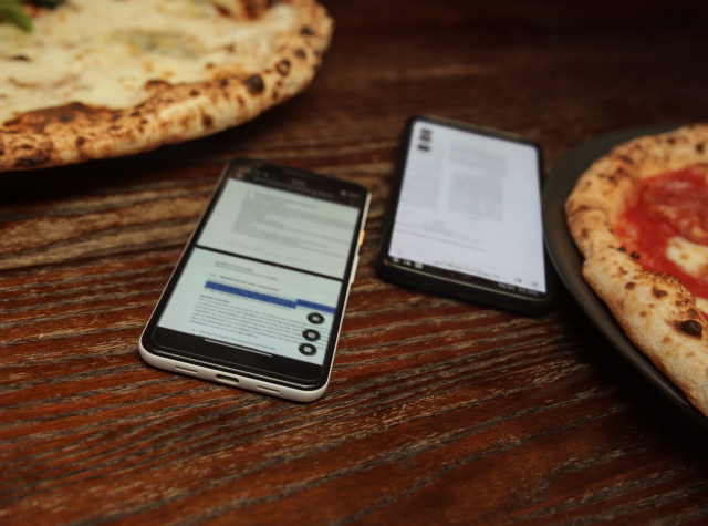 A Google Pixel 3A and a OnePlus 6, both running unmerged branches of Papers. On the Pixel you see a text selection. Next to them there are to pizzas.