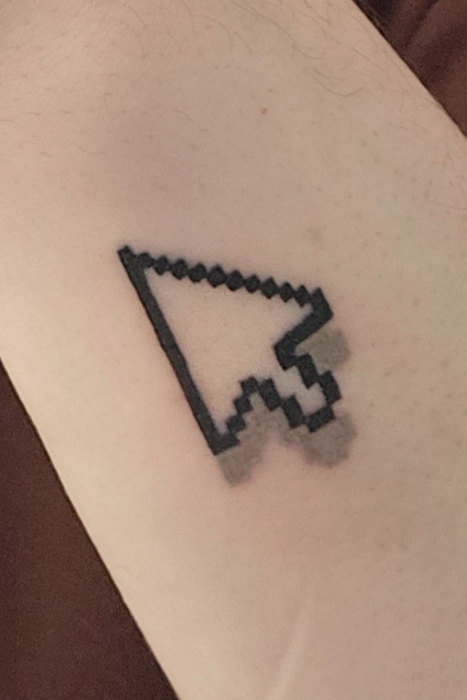 A closeup of the mouse cursor tattoo