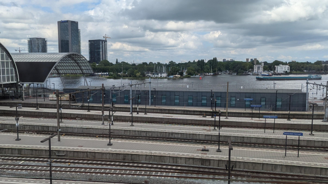 A picture of the station Amsterdam Centraal with a black building of Eurostar terminal being dismantled.