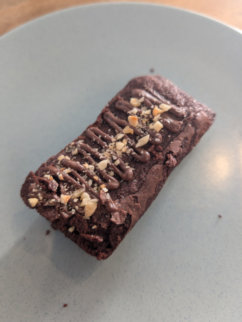 Rectangle chocolate brownie with chopped nuts on the top