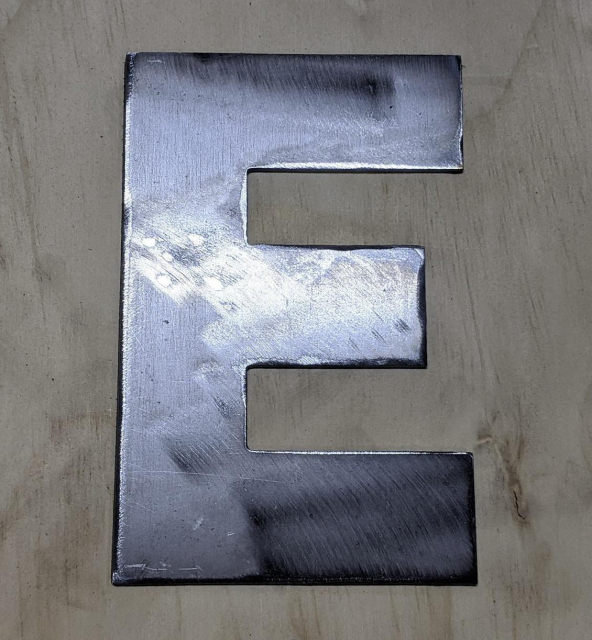 Photo of a capital letter E made from metal. 