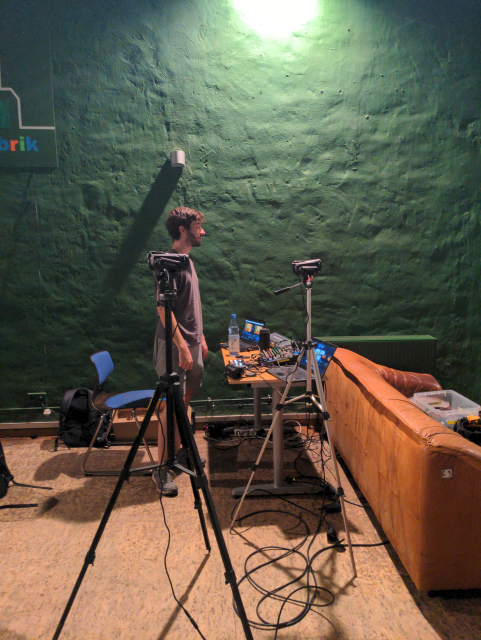 Jonas at the AV console at Regenbogenfabrik, with some laptops and cameras.