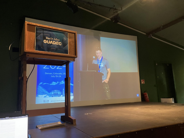 The GUADEC 2024 opening remarks projected on a large screen