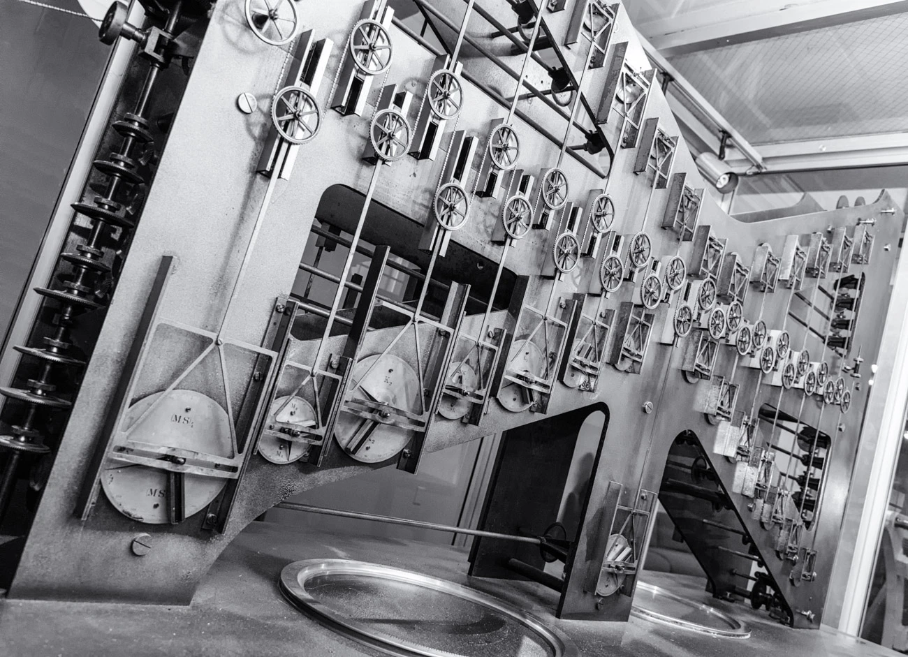 This photo shows the largest of the three sections of Tide Predicting Machine No. 2, a special purpose mechanical analog computer for predicting the height and time of high and low tides. The gears on the left transmit power from the hand crank.