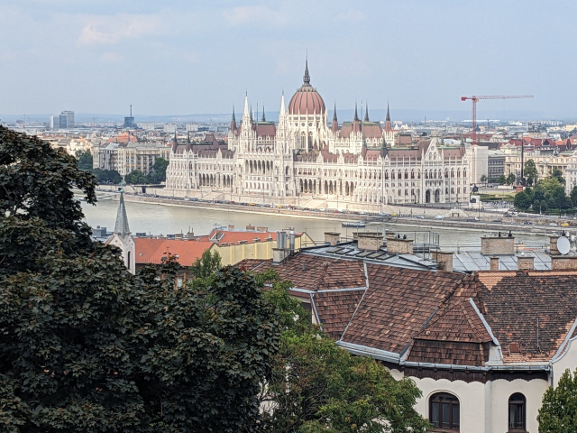 View over a huge parliament building next to a river.