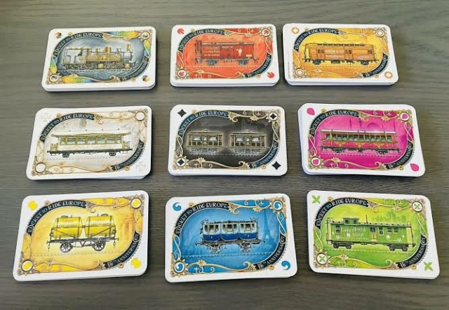 Cards from Ticket to Ride, with symbols in all four corners (colourblind friendly, too, although the carriage pieces in the same game are a problem)