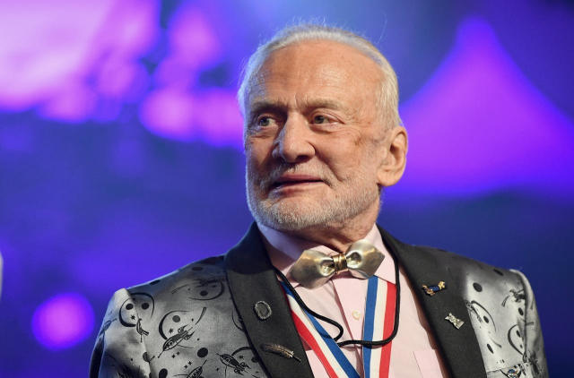 Photo of Buzz Aldrin in a jacket and wearing medals. 