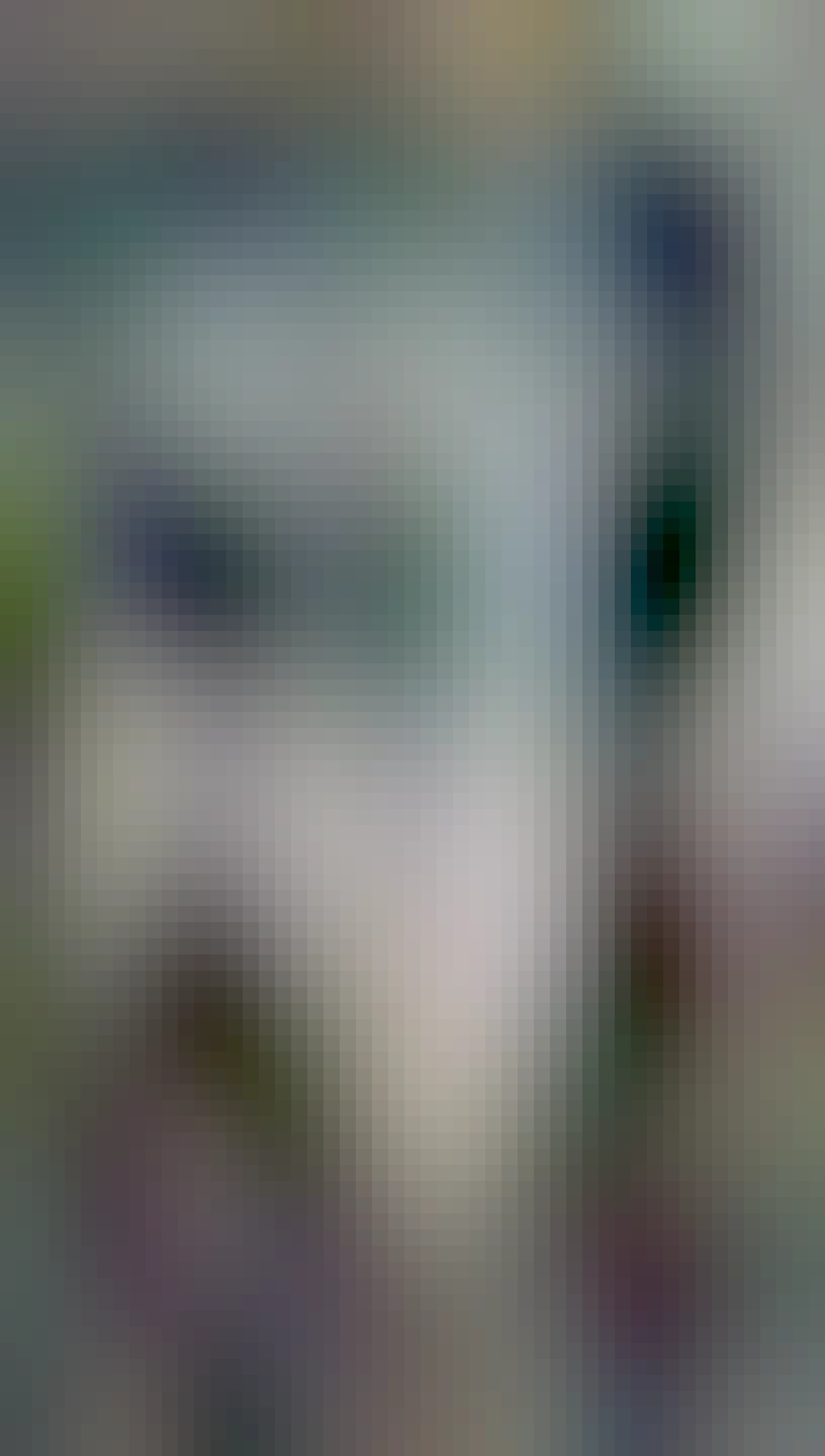 A meter cube backpack is on a table, the front flap is open and inside is a very shiny heat proofing sides. The outside is dark. There is a shelf for what looks like a pizza.