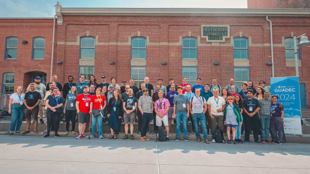 Group photo of GUADEC 2024 attendees standing outside Auraria Campus in Denver, Colorado