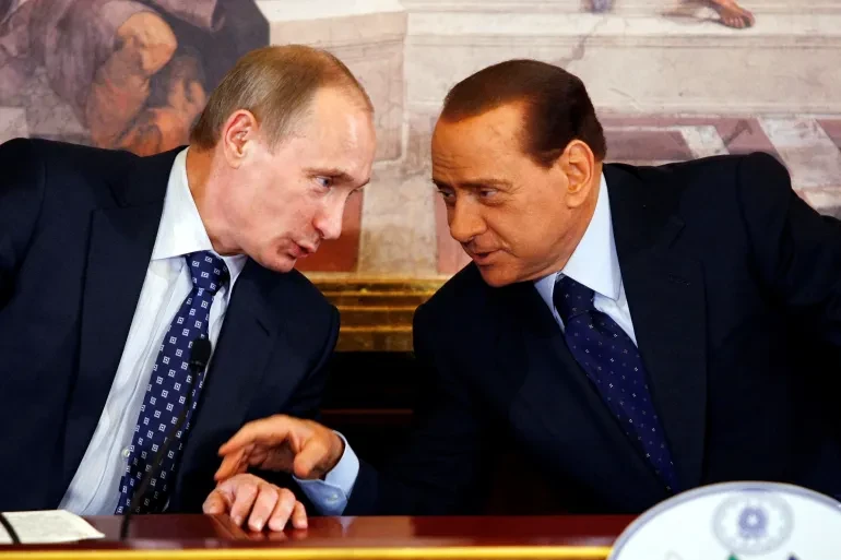 A picture of Russian dictator Vladimir Putin talking to former Italian prime minister Silvio Berlusconi.