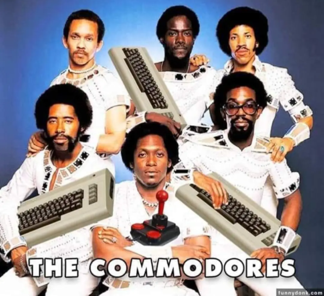 The Commodores holding Commodore 64 computers.