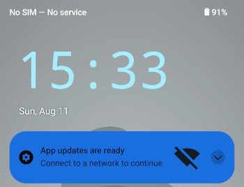 Screenshot from the Android homescreen showing clearly there's no network connection: status bar has "No SIM – No service", and no WiFi symbol to be seen. Still, a notifications shows "App updates are ready. Connect to a network to continue" – plus a symbol clearly stating no WiFi is available.