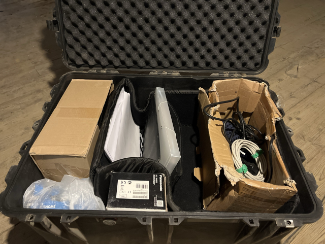 A big boxes full of conference swag for gnome, including banners, power extenders, Ethernet cables, wall adapters, flyers and much more.